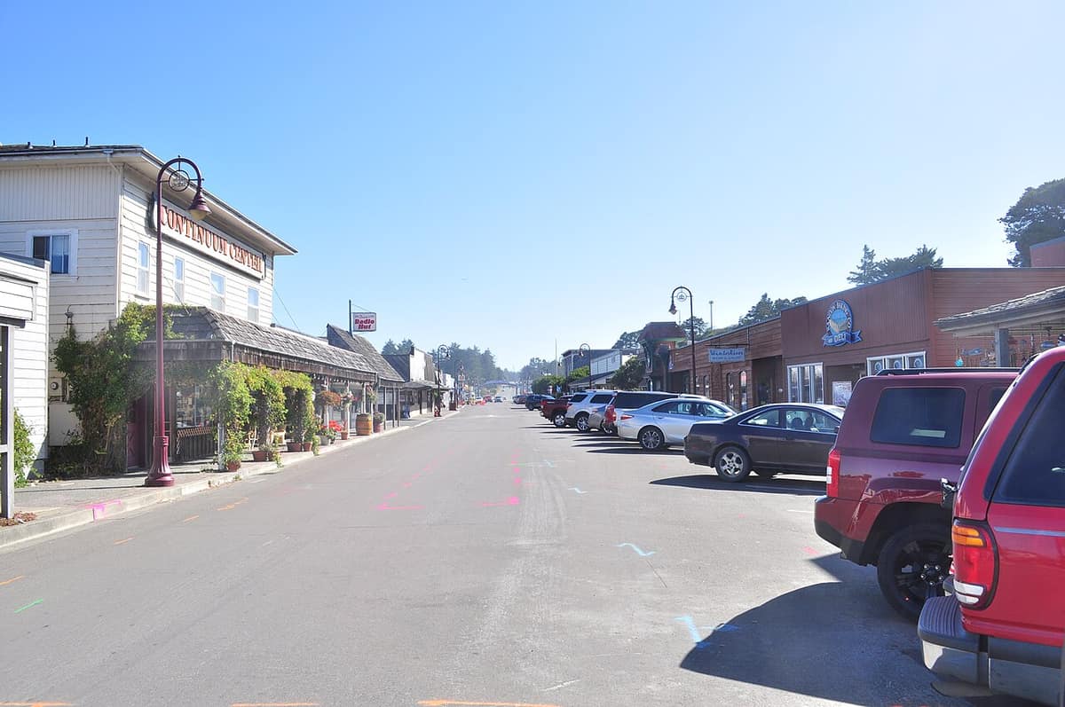 Second Street in Bandon Old Town, a quiet street lined with shops and parked cars