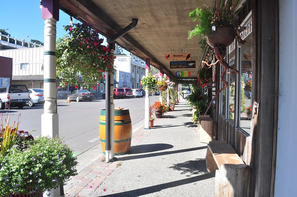 covered sidewalk with hanging flower baskets in Old Town Bandon