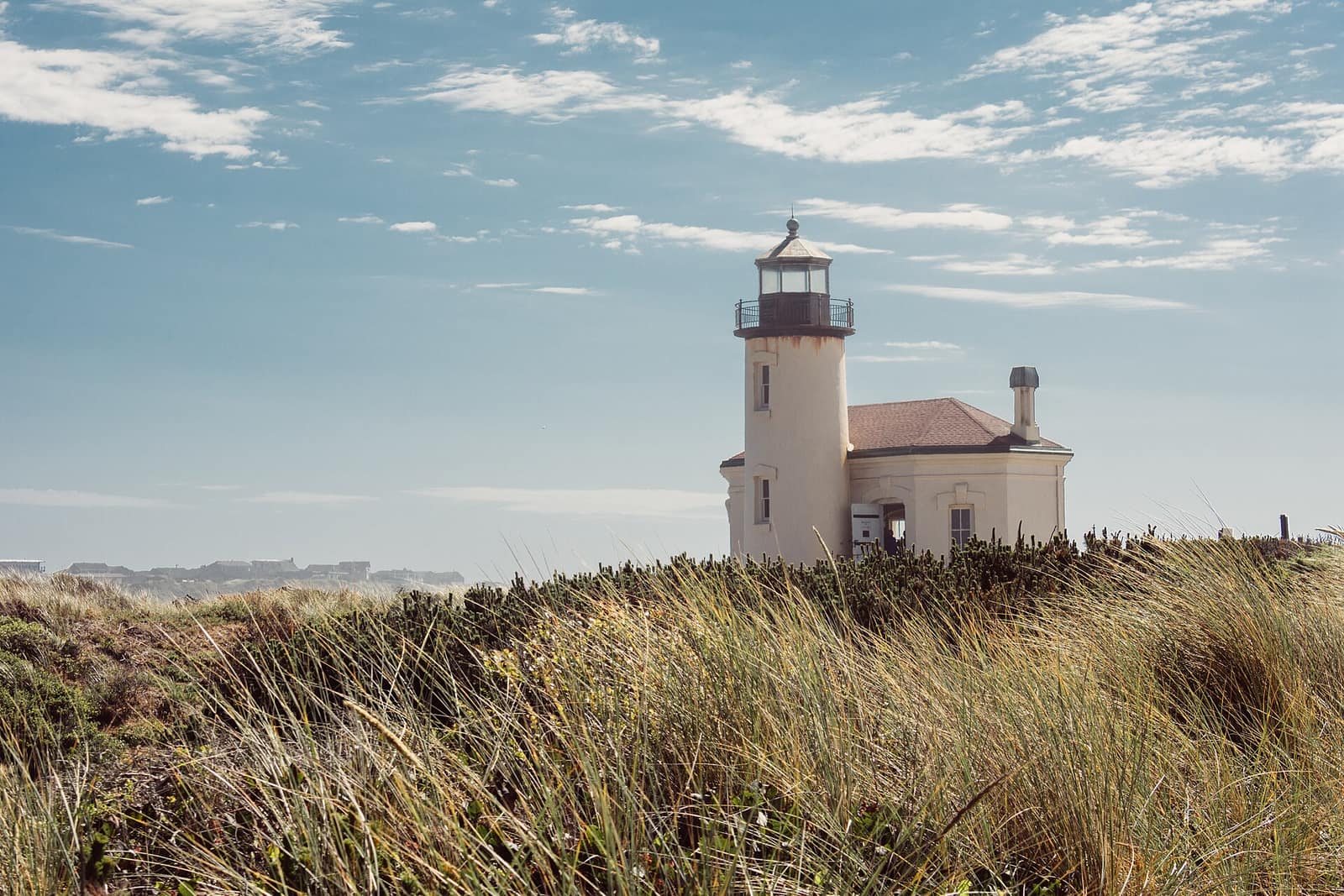 The Coquille River Lighthouse near Bandon rising above windblown dune grass