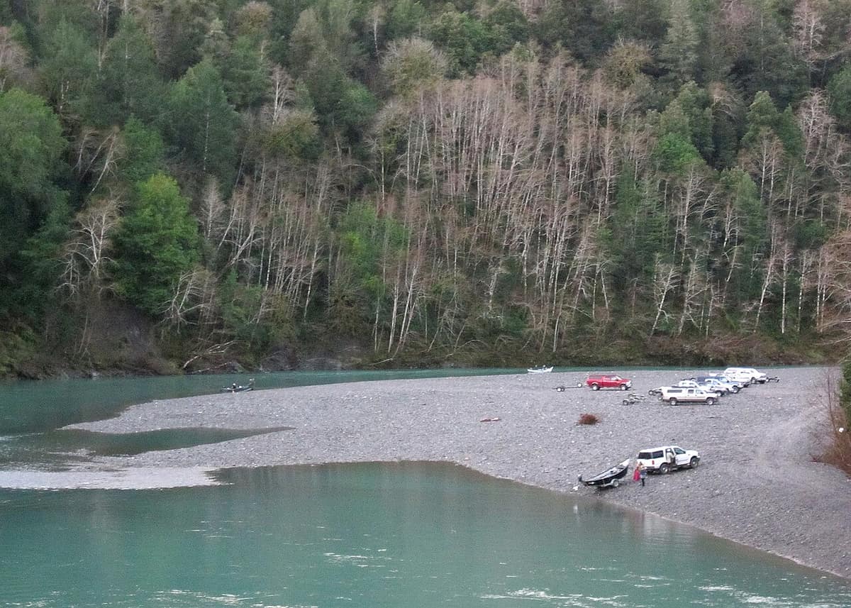drift boats and trucks on a gravel bar along the Chetco River