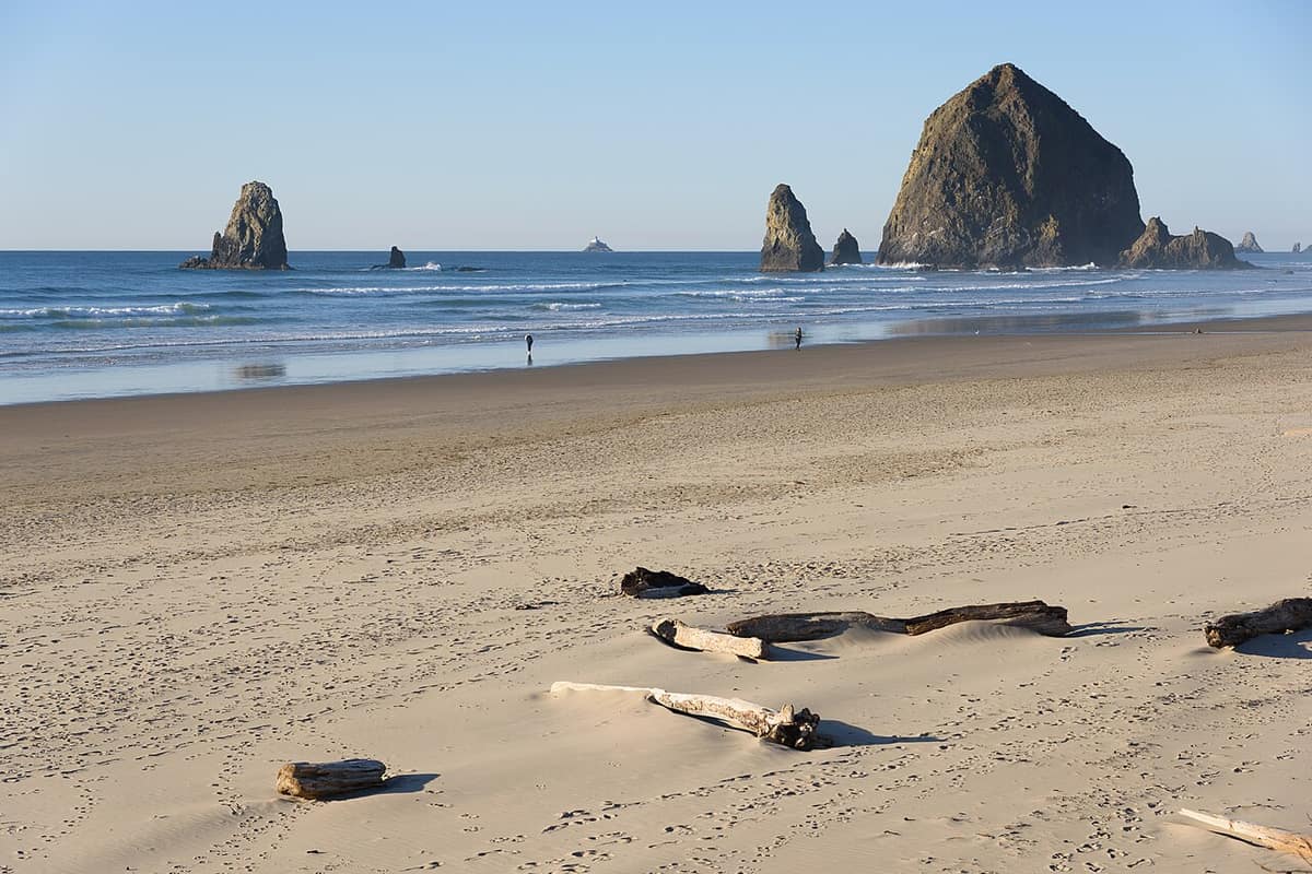 Haystack Rock and offshore sea stacks seen across the beach at Cannon Beach