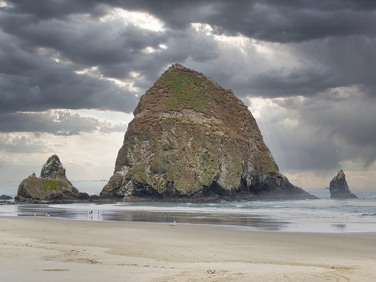 Haystack Rock under heavy storm clouds at Cannon Beach
