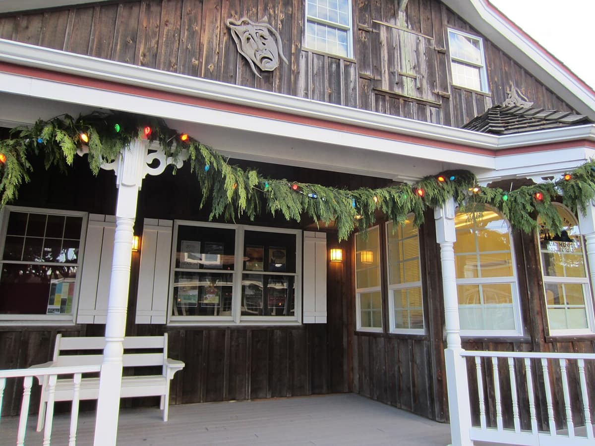 downtown Cannon Beach building with theater masks and holiday garland