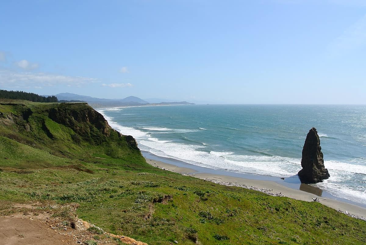 Green bluffs and a sea stack at Cape Blanco, looking south along the Oregon coast